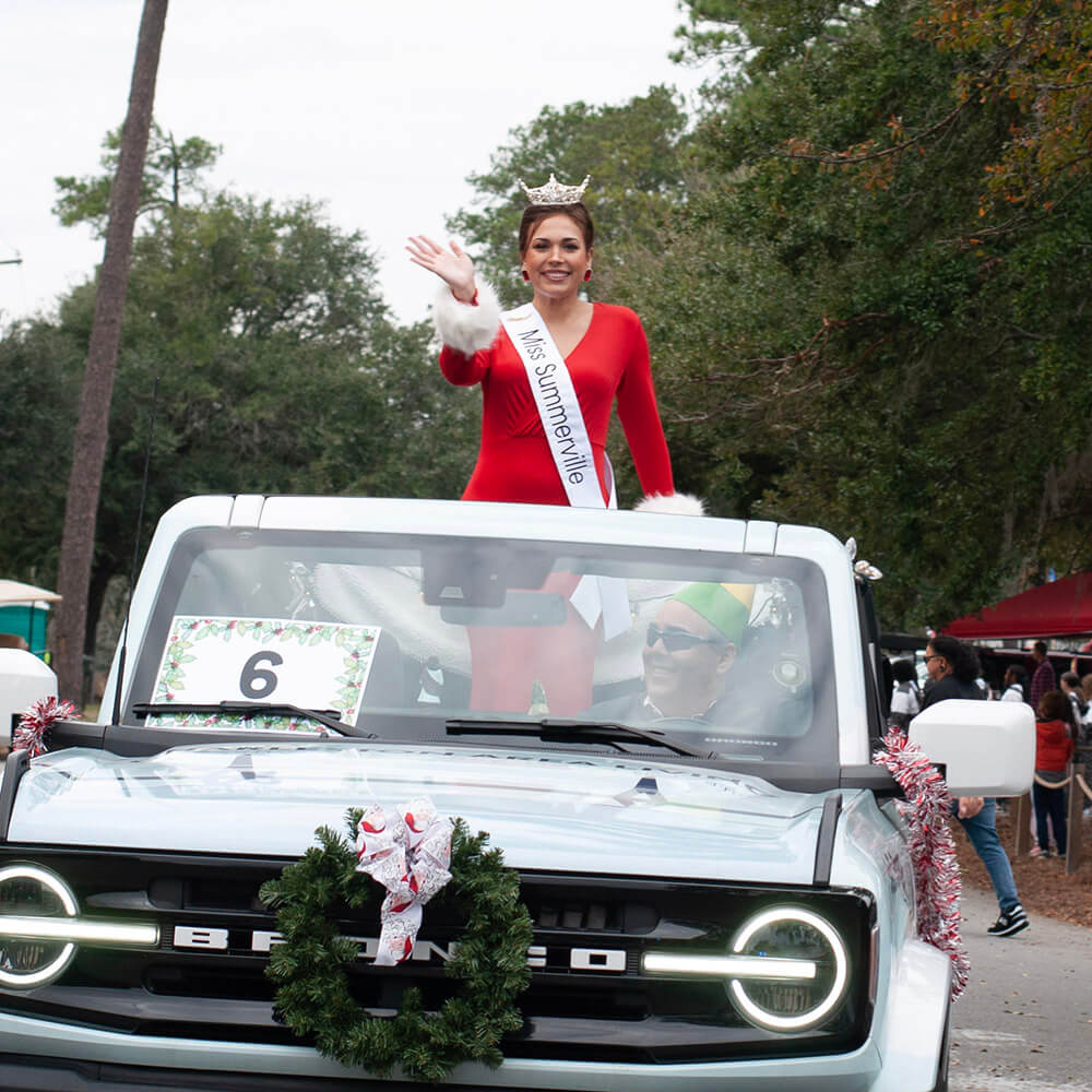 A wreath-decorated truck rolls down Main Street in the Summerville Christmas Parade