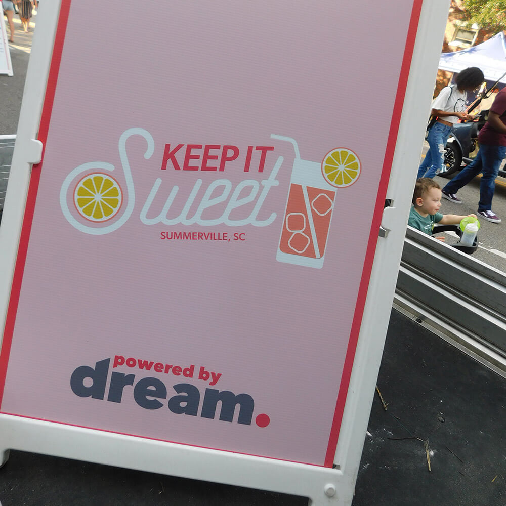 A “Keep It Sweet, Summerville SC” sidewalk sign at the festival
